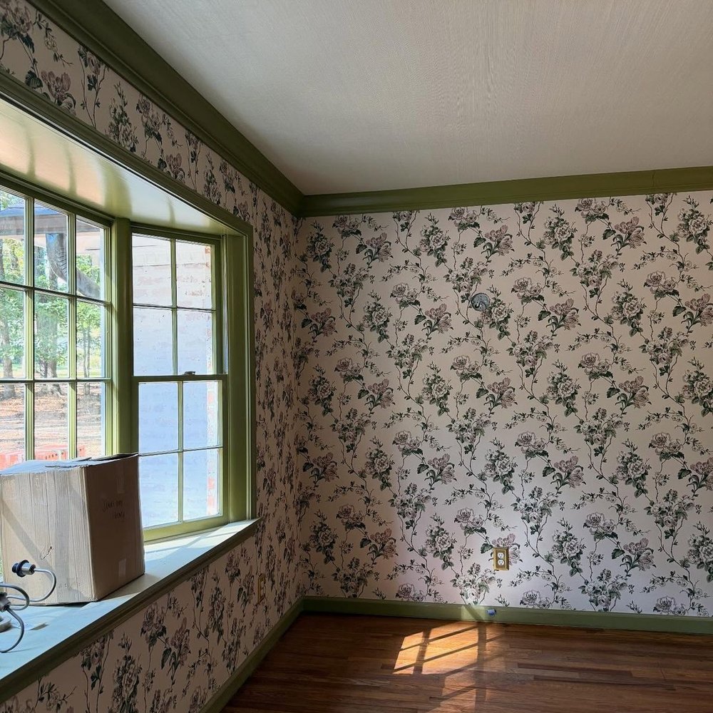 Wallpapered room with a refined interior palette